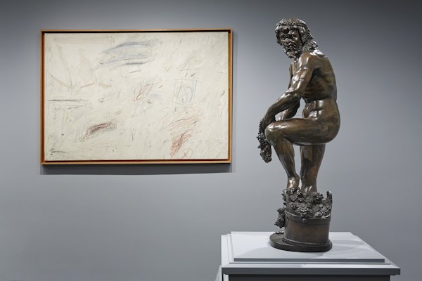 Installation view at The Frick Collection showing Adriaen de Vries’s, “Bacchic Man Wearing a Grotesque Mask” with Cy Twombly’s, “Untitled”, 1959, ©Cy Twombly Foundation, both works from the Collection of Mr. and Mrs. J. Tomilson Hill; photo: Michael Bodycomb