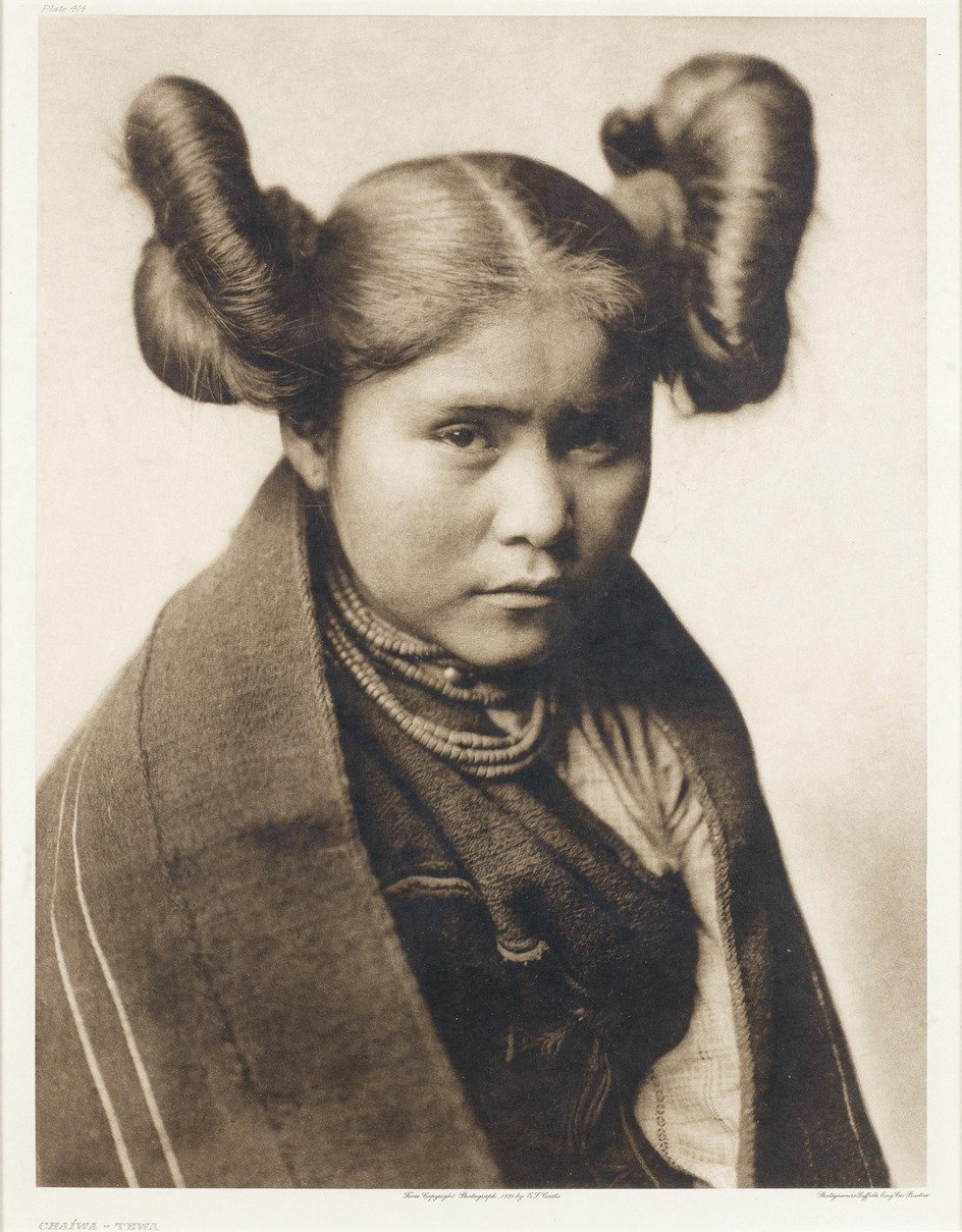 a native american woman with elaborate haircut