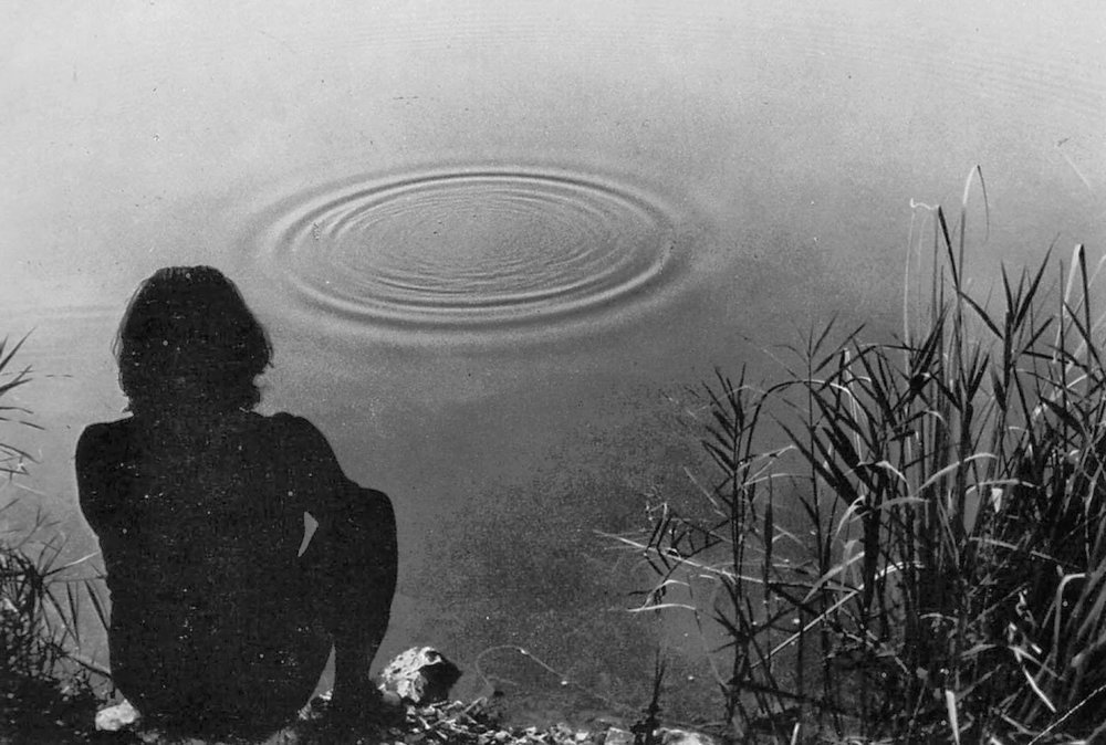 a man stares at some circles in the water