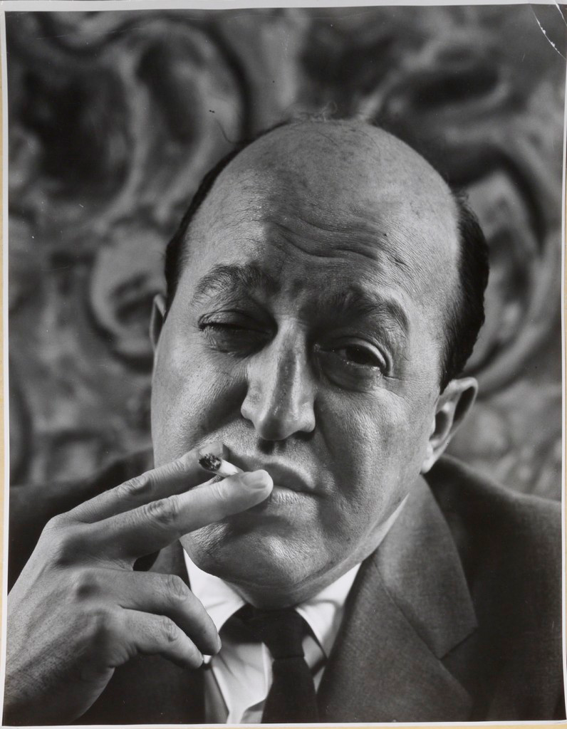 A black and white of critic Clement Greenberg raising his eyebrows